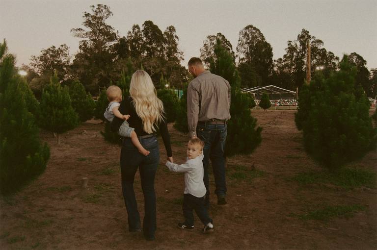 Parents and children cuddling together outdoors