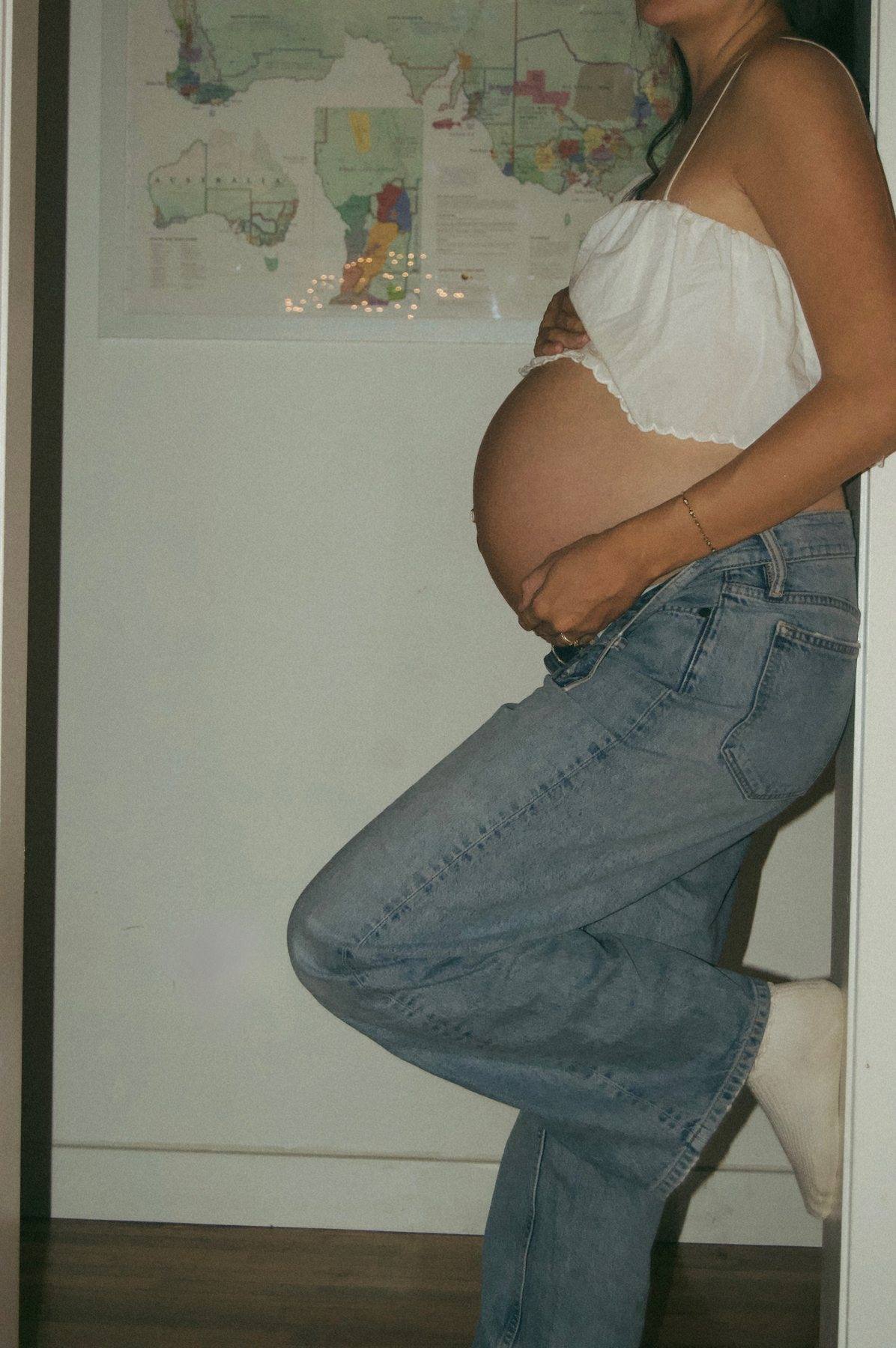 Expecting mother seated during a maternity session